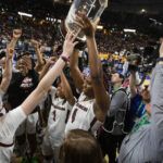 
			
				                                South Carolina’s Aliyah Boston holds up the championship trophy after defeating Tennessee 74-58 to win the championship game of the Southeastern Conference women’s tournament in Greenville, S.C., on Sunday.
                                 AP photo

			
		
